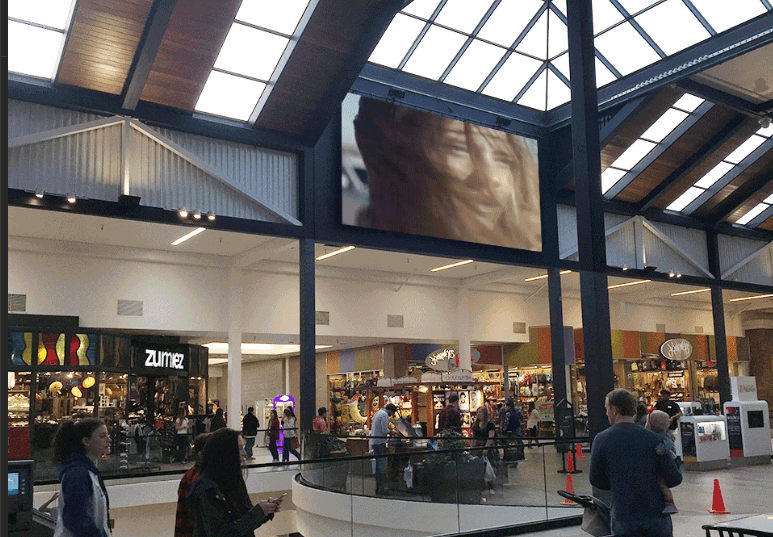 A digital spectacular display above a shopping centre concourse